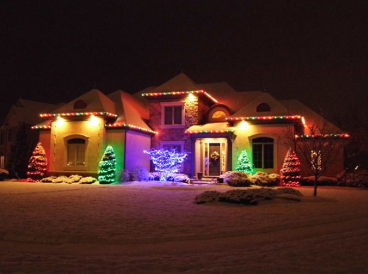 Home with exterior multicolored holiday lighting installation